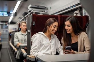 Girls in the seat car comfort look at smartphone